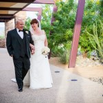 Bride and groom walking outside reception hall