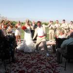 bride and groom recessional with flower petals on the ground