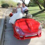 bride and groom on Corvette shaped golf cart