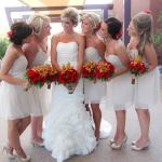 bridal party looking at flowers and each other 