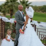 bride and groom with child on balcony