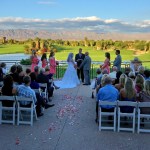 Bride and groom on terrace overlooking the golf course green