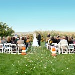 Autumnal wedding aisle with pumpkins and white/orange flower petals