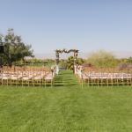 Wedding ceremony seating with flower covered canopy 