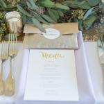 Green and gold table setting with menu