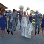 Bridal party jumping in midair