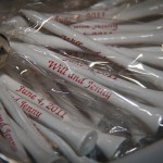 Golf tees labeled as "Will and Jenny" for wedding party favors 