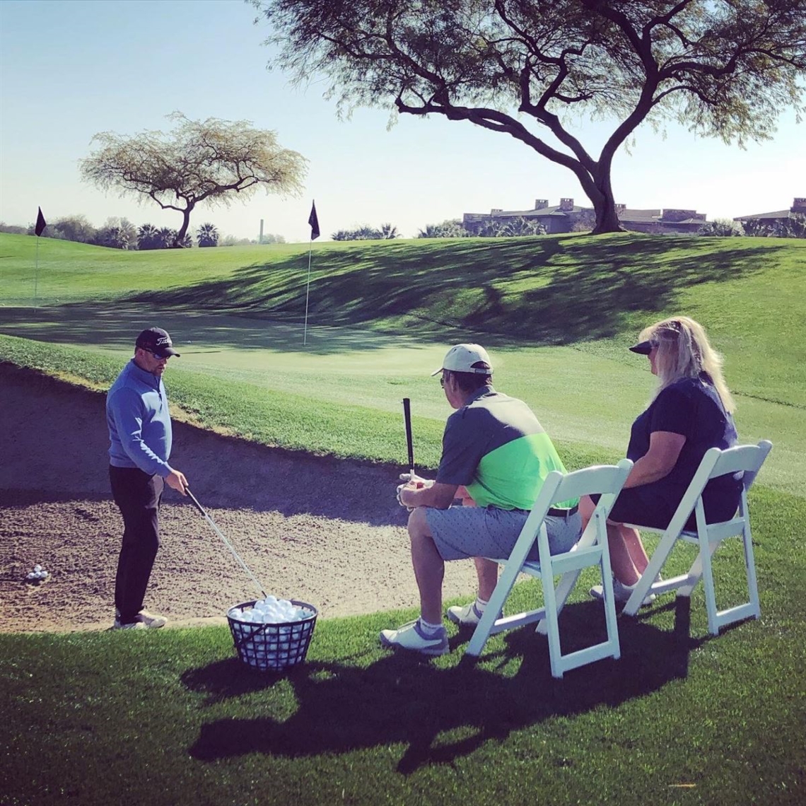 Instructor giving lesson on golf course