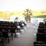 Ceremony seating with white flowers and a purple accent