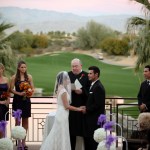 Bride and groom saying vows on terrace overlooking golf course 