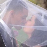 bride and groom smooching under veil