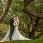 Bride and groom under low leaning trees