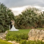 Bride and groom near stream on golf course 