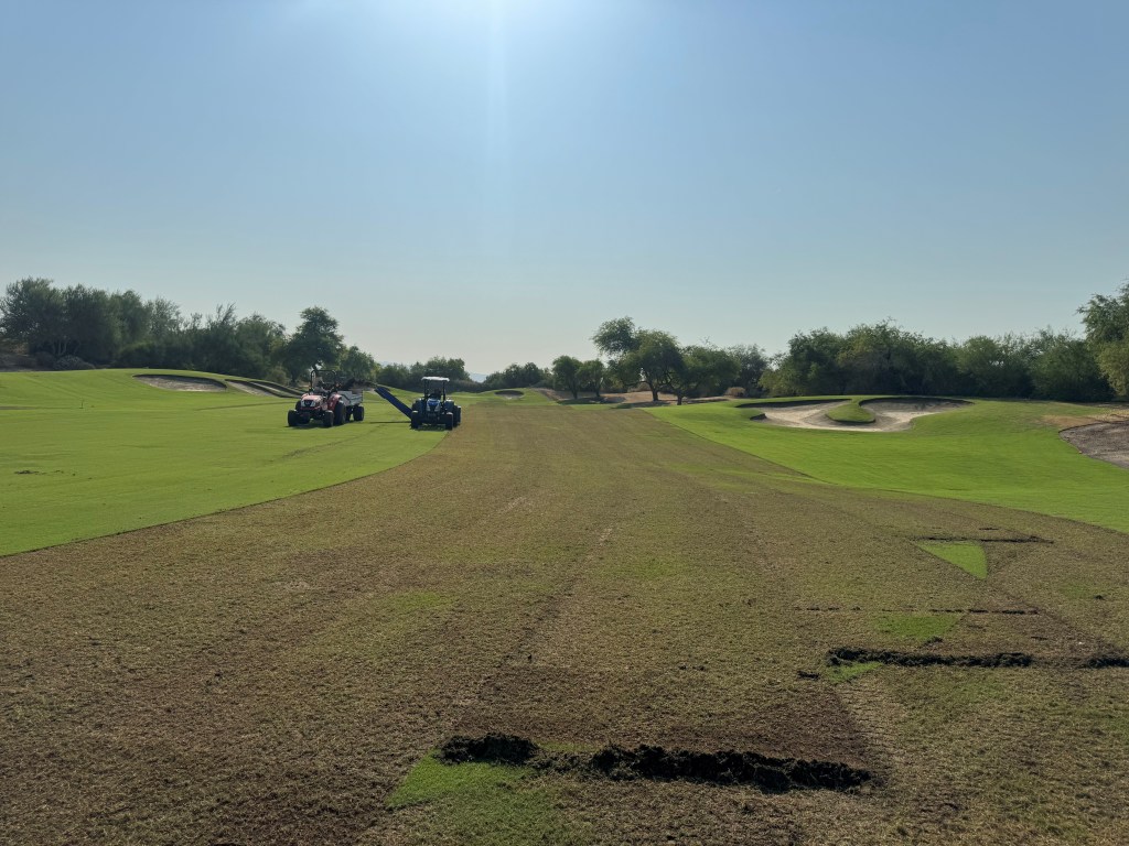 Golf course maintenance crew using tractors for turf reduction and aggressive verticutting on Mountain View fairway at Desert Willow Golf Resort.
