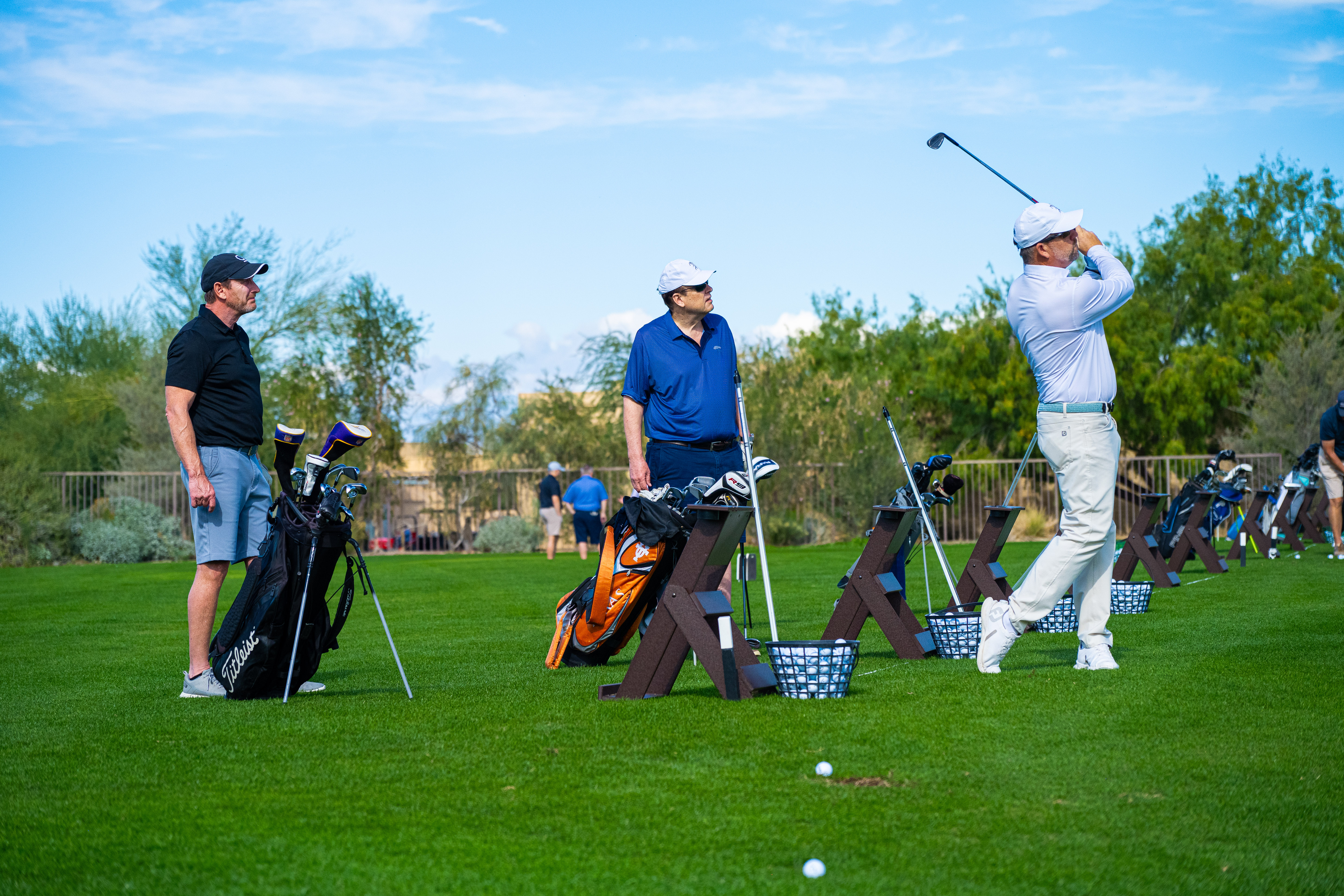 Golf student practicing under the guidance of PGA Professional Paul Bucy during the 2-Day Signature Golf School at Desert Willow Golf Resort, with testimonial overlay praising the program as the best investment in improving their game.
