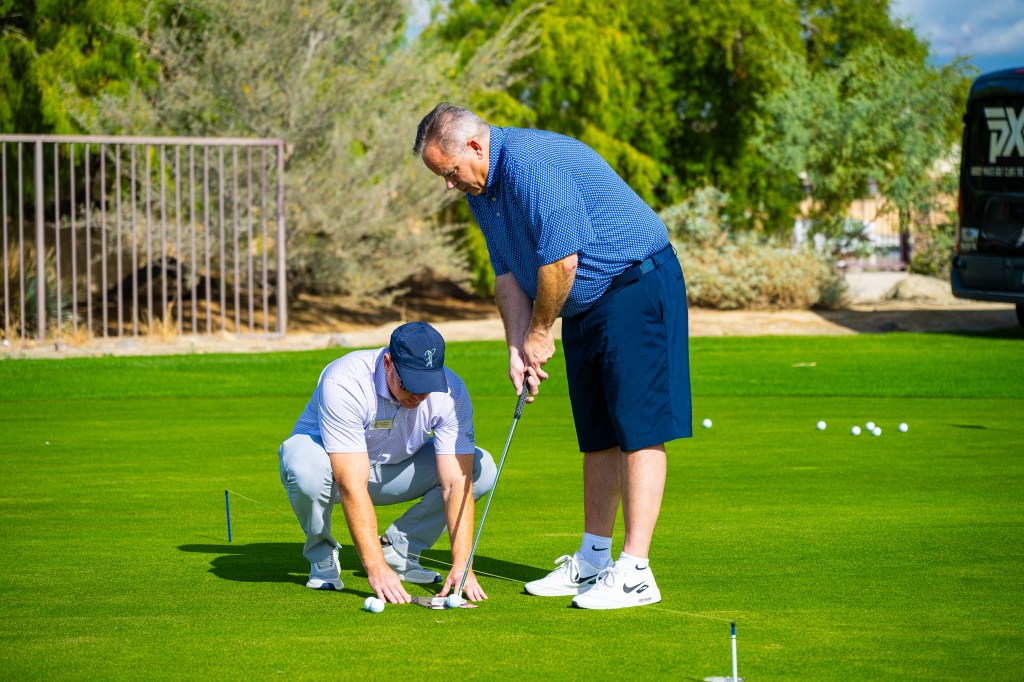 PGA Professional providing one-on-one putting instruction to a golfer during a private lesson at the Palm Desert Golf Academy at Desert Willow Golf Resort.