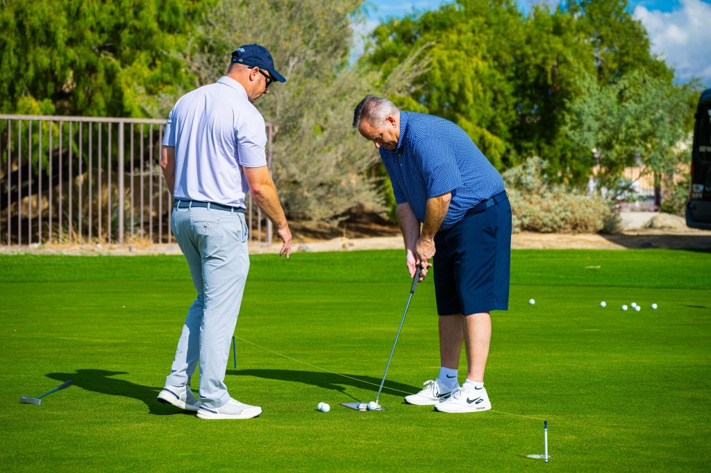 PGA Professional instructor coaching a golfer on putting technique at Palm Desert Golf Academy, Desert Willow Golf Resort, during the Mastering the Short Game school.