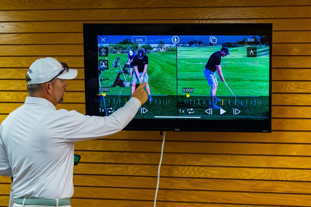 PGA professional using OnForm video analysis software to review a student’s golf swing during instruction at Palm Desert Golf Academy.