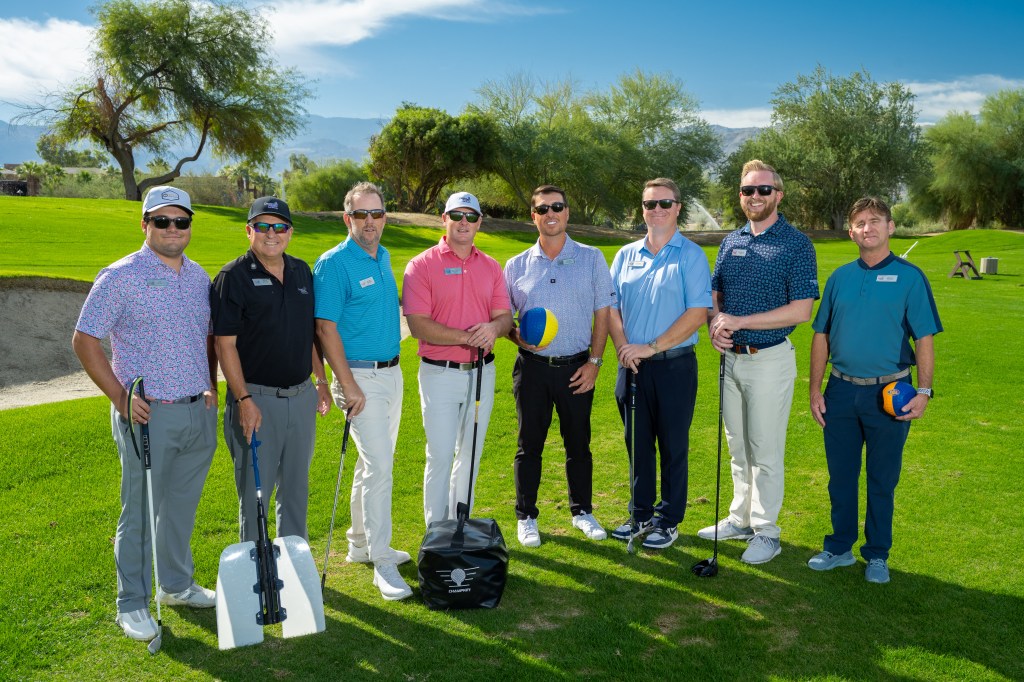 Group of PGA Professionals standing together on the golf course at Palm Desert Golf Academy, ready to lead the One-Day Performance Golf School at Desert Willow Golf Resort.