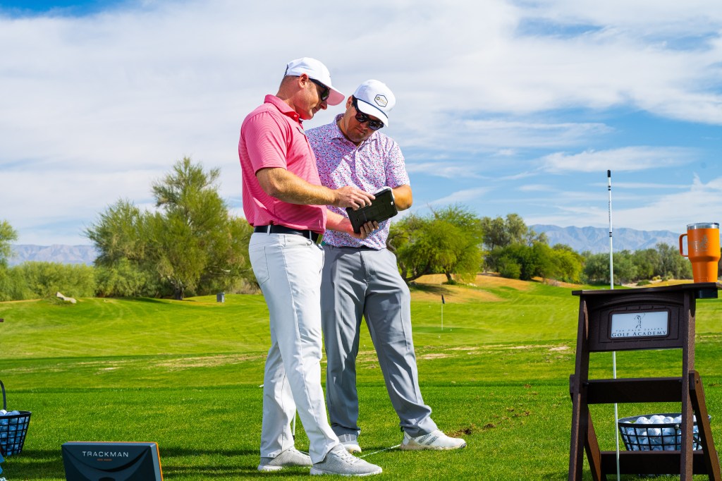 PGA Professional reviewing personalized practice plan with golf student on course during the One-Day Performance Golf School at Desert Willow Golf Resort.