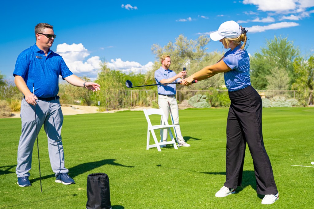 Beginner golfer practicing swing during the Get Golf Ready program at Palm Desert Golf Academy, guided by PGA instructors, with program pricing and schedule details displayed.