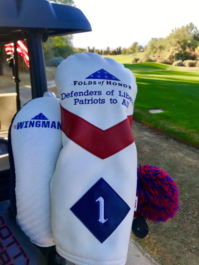 Folds of Honor golf club headcover on golf cart at Desert Willow Golf Resort for the Folds of Honor tournament.