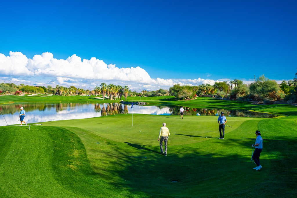 Foursome on the green at Desert Willow Golf Resort